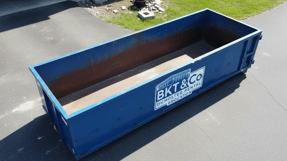 Two-family and triple-decker turnovers in Brockton — roll-off container on a make-ready in Montello